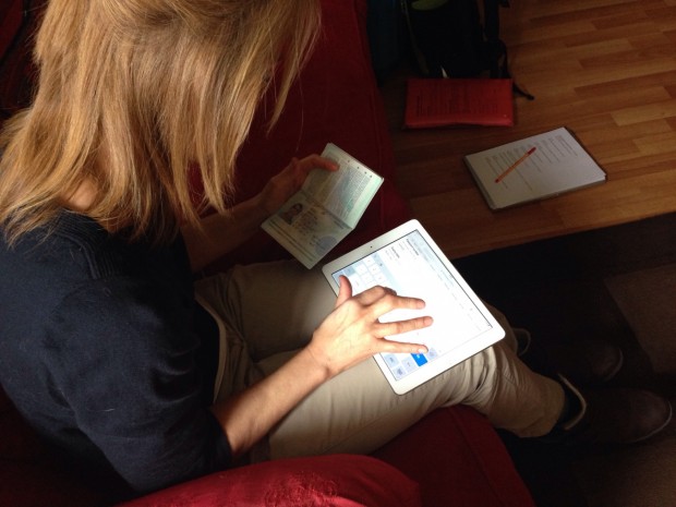 Photo of research participant with arthritis in her fingers using tablet for Passports service