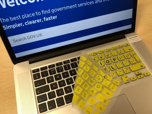 Laptop keyboard with high visibility silicone skin (large black characters on yellow keys)