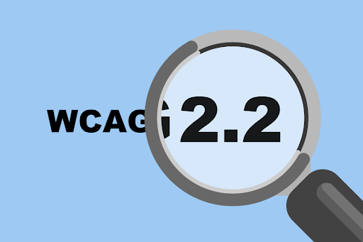 An illustrated magnifying glass hovers over bolded text that reads ‘WCAG 2.2’, greatly magnifying the ‘2.2’ portion of the text