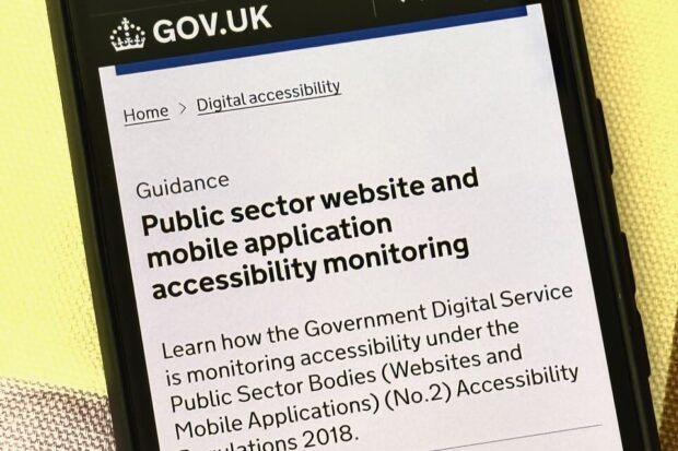 A mobile phone displaying a webpage from GOV.UK about public sector accessibility monitoring